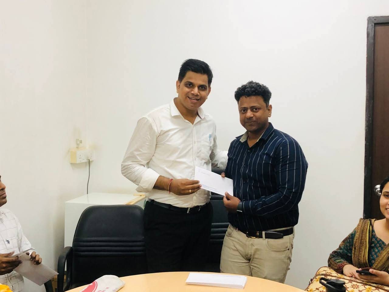 Dr. Yadav presenting being felicated by the principal of Mvlu college Dr Mahendra Kanojia