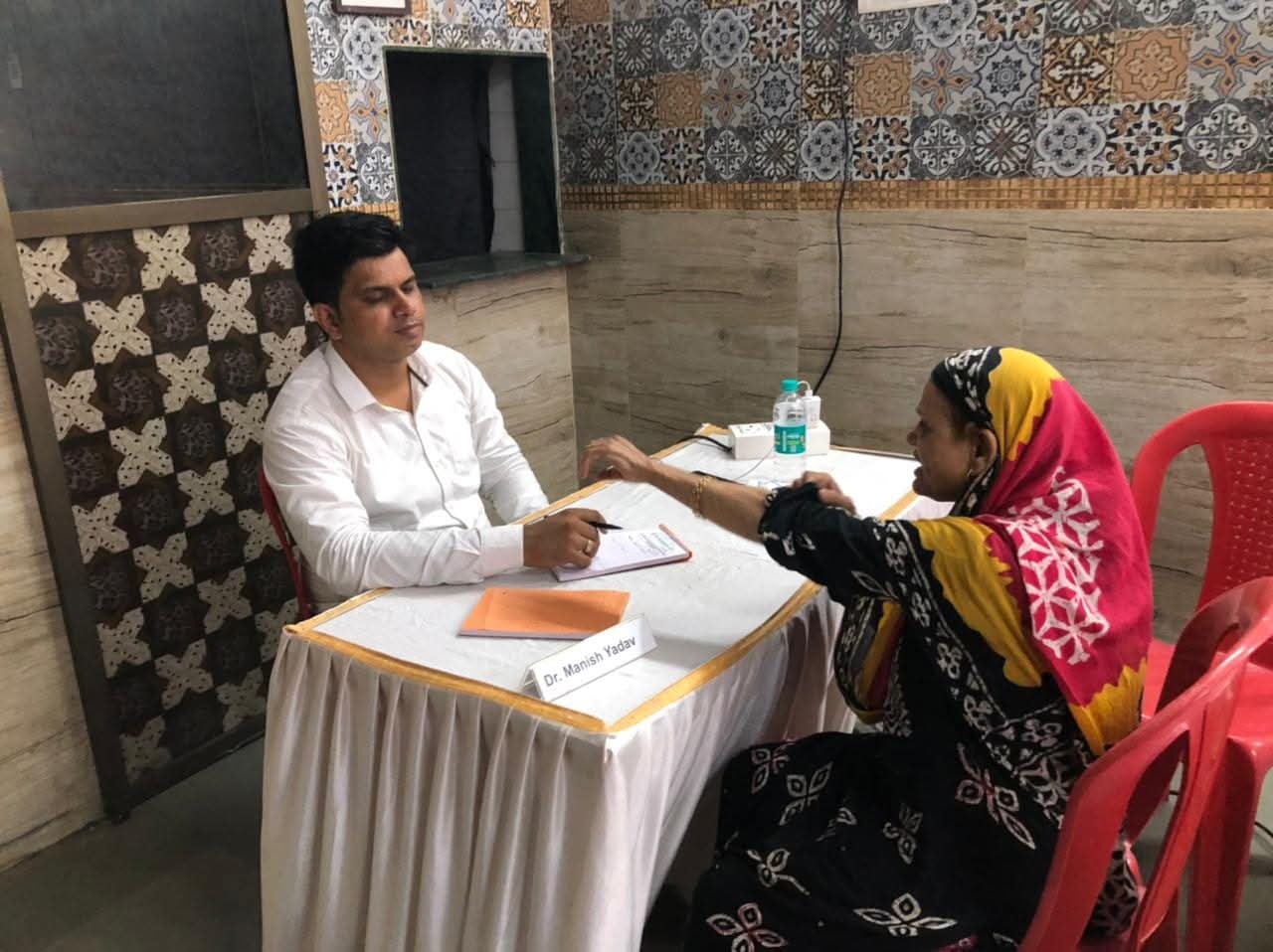 Doctor Manish Yadav consulting patients during medical camp in Mumbai